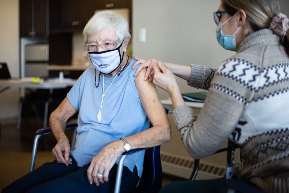 Heartland Retirement resident Helga Seiser receives her first dose of the Moderna COVID-19 vaccine from an AHS nurse in Okotoks on Jan. 7. Senior facilities across the Foothills are receiving a COVID vaccine this month. 