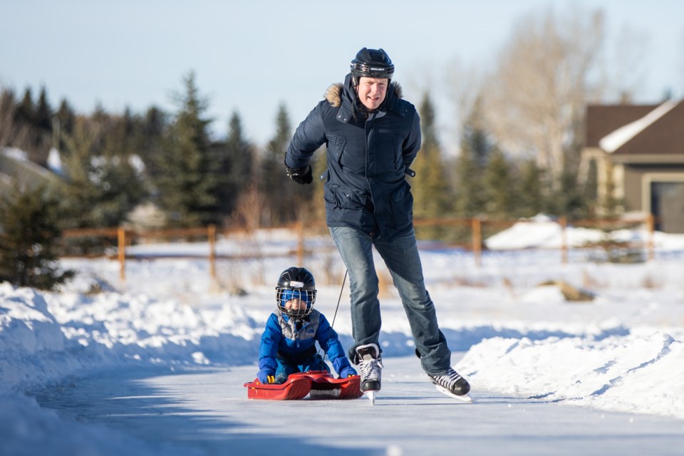 Fraser Boyd pulls his son James around the new ice track at the ball diamond in Laudan Park on Jan. 9. The park is situated just west of downtown on Highway 549 and already boasts cross-country ski tracks and a walking path through the frozen wetland.