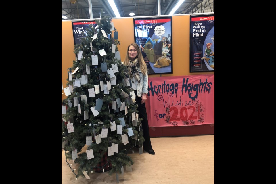 Nancy Bowlby, Heritage Heights School learning commons co-ordinator with the school's Wishing Tree. (Photo submitted)