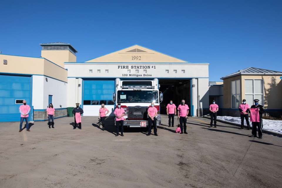 Members of the Okotoks Fire Department, Okotoks Municipal Enforcement, Okotoks RCMP and Town staff gather in front of the fire hall for Pink Shirt Day on Feb. 24.