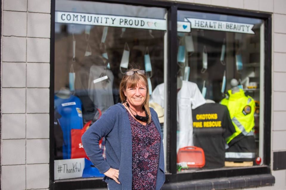 Corey King, manager of Main Street Market and More, in front of her storefront window on March 3. King decorated the space as a tribute to frontline workers as thanks for their efforts during the COVID-19 pandemic.