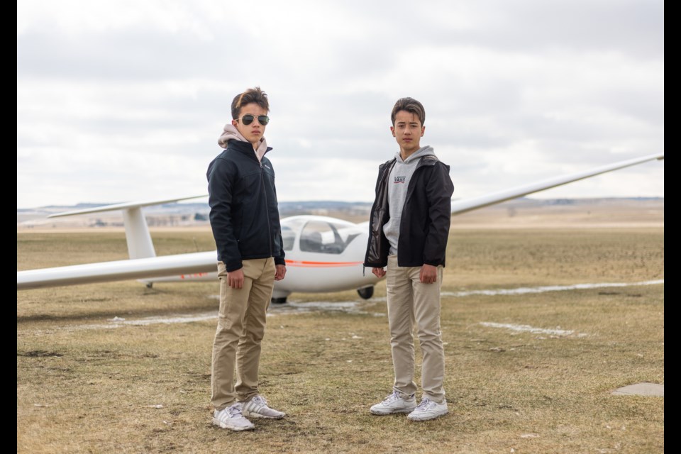 Twins Kaleb (left) and Joshua Bagrowicz in front of an ASK-21B glider at Cu Nim Gliding Club on April 23. The two 14-year-olds each conducted their first solo flights in the glider on April 17, a feat rarely accomplished at such a young age.