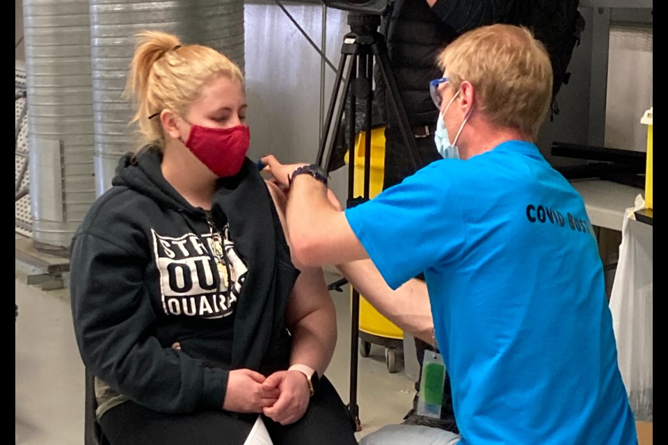 Cargill worker Jamie Welsh-Rollo gets her Moderna shot at the plant near High River on April 29. A team of doctors and other medical professionals began vaccinations that morning, with over 1600 of the plant's estimated 2000 workers pre-registered. (Photo courtesy Joe Attwood/UFCW)