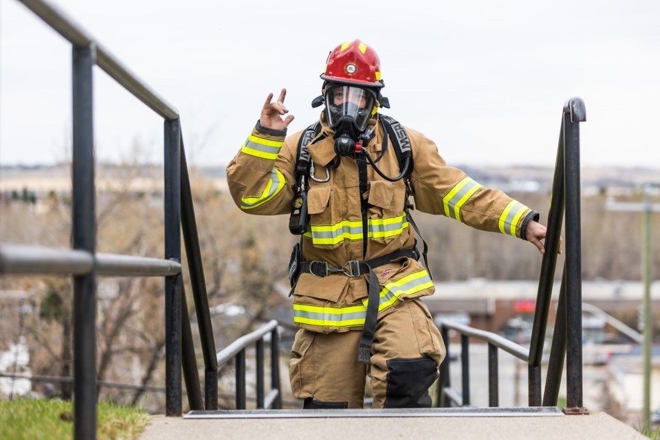 Okotoks firefighter Ian McLeod ascends the stairs behind Clark Ave. and Elma St. on May 7 during the Calgary Firefighter Stairclimb Challenge. Held in Calgary's Bow building in past years, Okotoks firefighters took to the stairs behind Clark Avenue between May 2-15, ascending 15 times for the required 1,204 steps up. The event is organized by Wellspring Calgary, which supports firefighters and others dealing with cancer, as well as their families. In addition to firefighters climing throughout the week, other responders such as two RCMP members also took part.