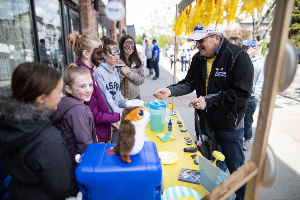Bill Robertson, here buying lemonade from youths during Lemonade Day, had a way with children, said former teachers. (Brent Calver/Wheel file photo) 