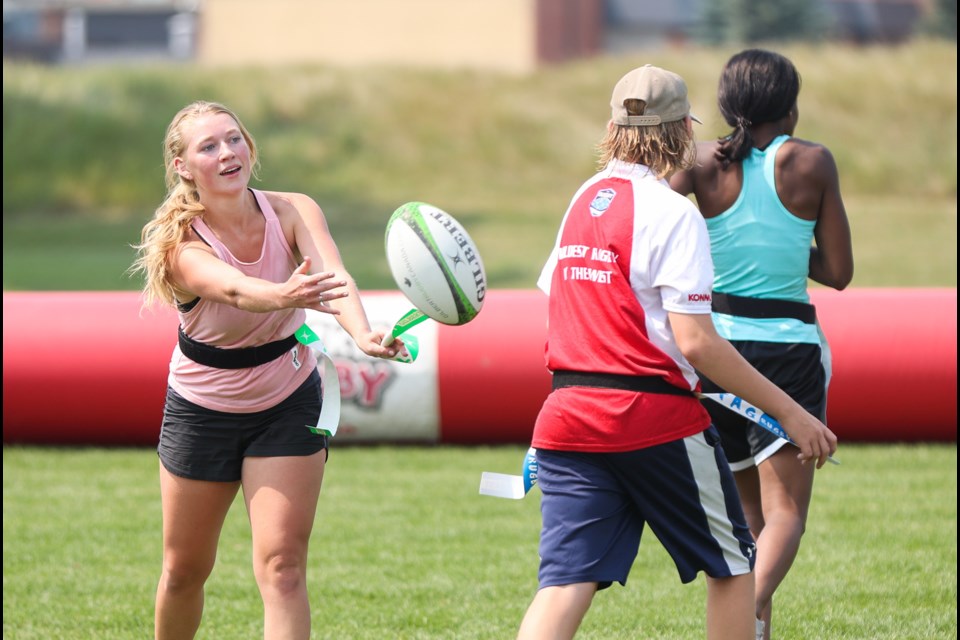 Tara Fenner passes the ball during Rugby Alberta's Try Rugby  on July 25 at Wylie Park in Okotoks. 