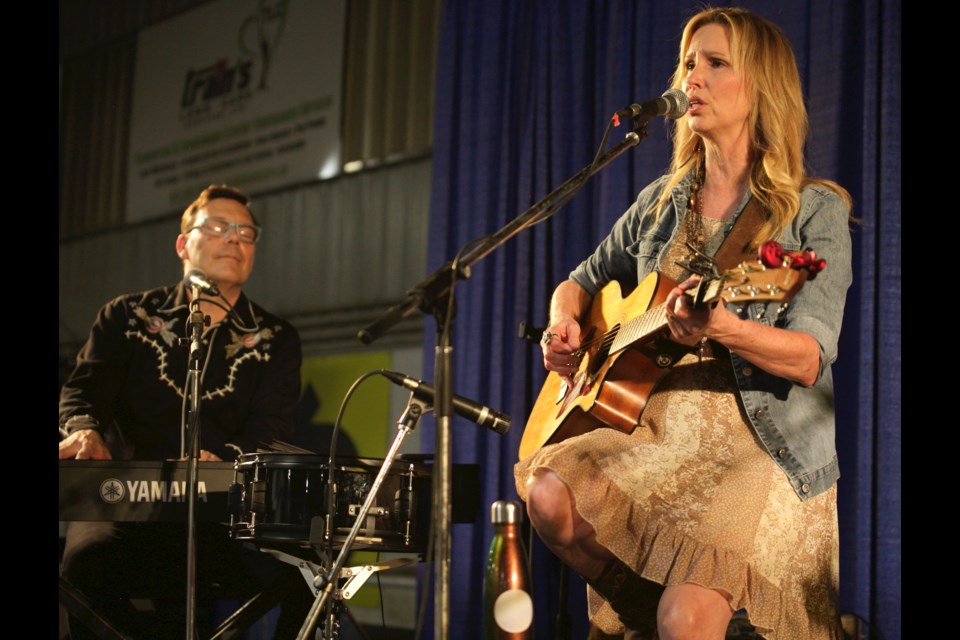 Lana Floen of the Travelling Mabels sings a song from their upcoming album while Keith Floen plays keyboard at a concert at the Train's Landscaping Agriplex at the Okotoks Ag Society grounds.