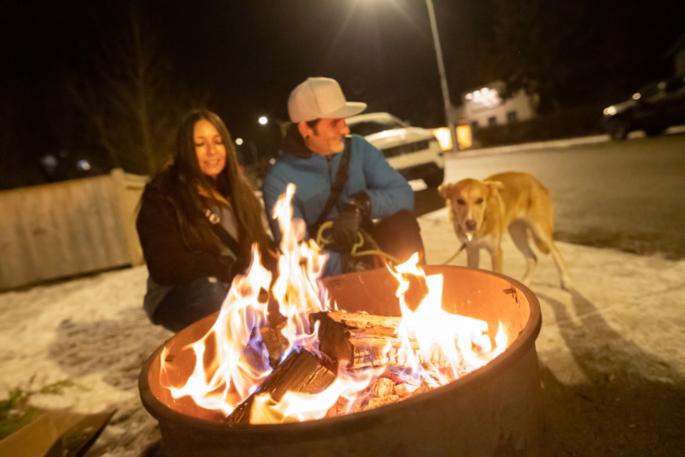 People warm up by a firepit outside Bertie's General Store during Light Up Black Diamond on Dec. 4, 2021. This year's event sees the return of wagon rides and Santa Claus to kick off the Christmas season in the High Country.