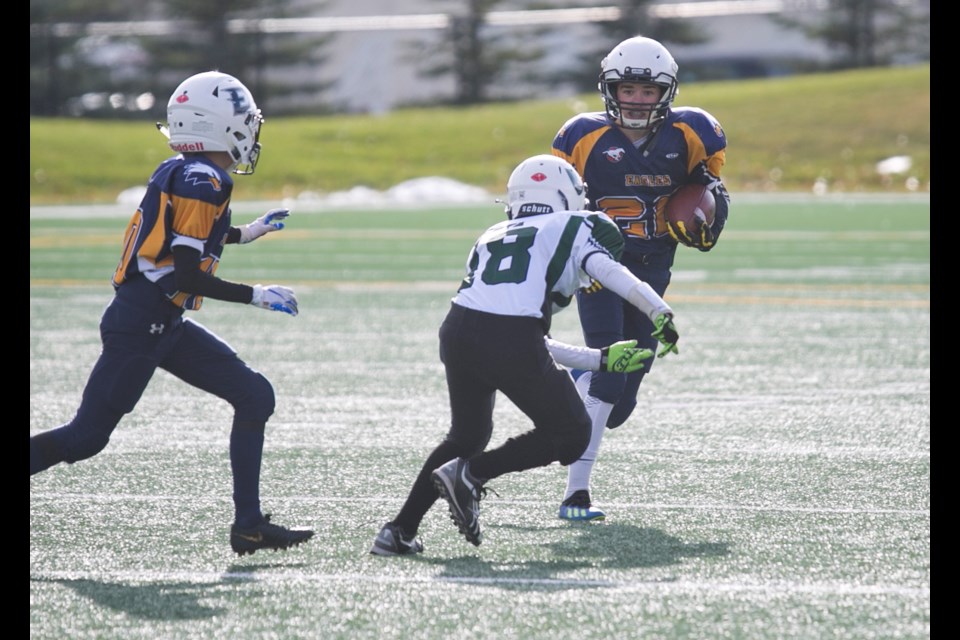 Foothills Bantam Eagle Tyson Sopp tries to evade a tackle from the Calgary Hilltoppers with Rylan Neish arriving to make a block during the Eagles' 34-0 win in the CBFA Tier III semifinal, Oct. 19 at Shouldice Park.
(Remy Greer/Western Wheel) 