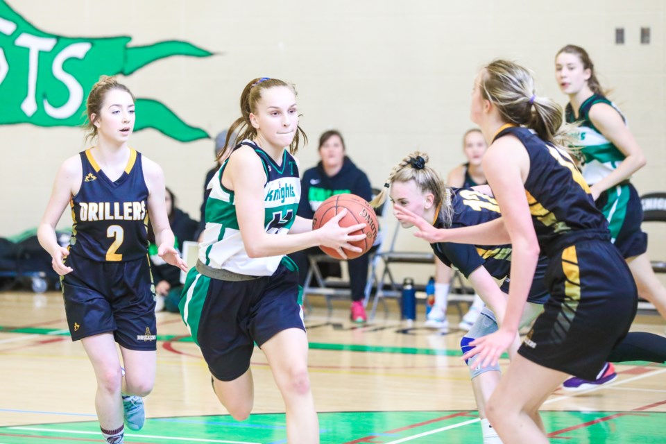 Holy Trinity Academy Knight Kylie Tiedje drives to the basket against the Oilfields Drillers in the Foothills Athletic Council girls championship. The Knights won by a 78-41 score. (Brent Calver/Western Wheel)