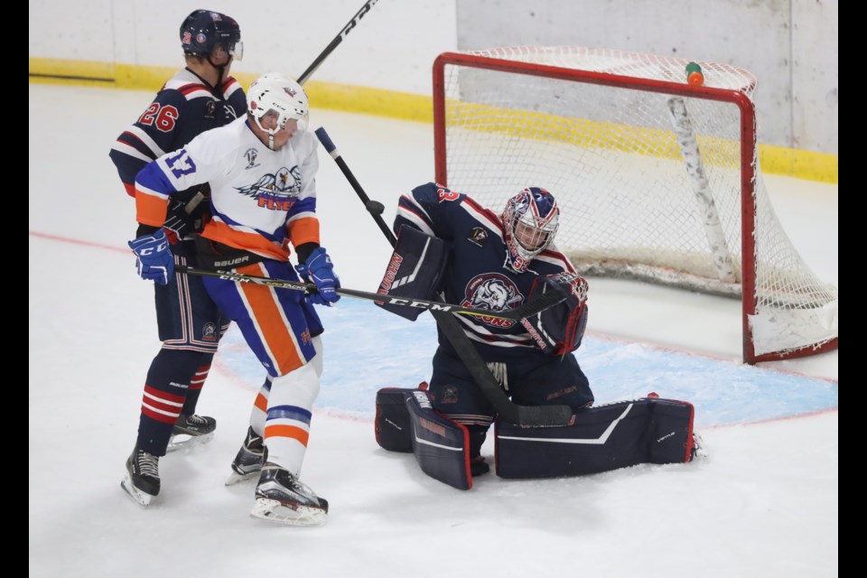Okotoks Bison Devin Reagan blocks a shot with High River Flyers Chase Groeneveld providing a net-front presence during Okotoks' 6-1 win on Sept. 20 at the Murray Arena.
(Brent Calver/Western Wheel)