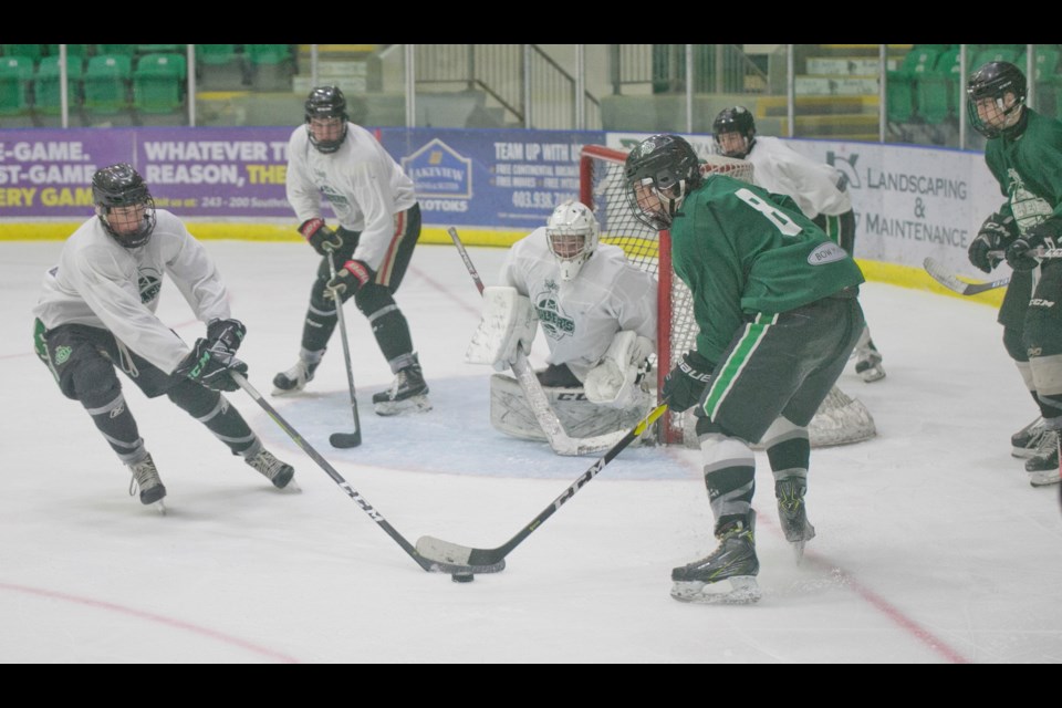Okotoks Bow Mark Oilers prospects Hayden Schmidt, left, and Ethan McIntyre battle in front of goal during the Green & White Game on Sept. 7 at Pason Centennial Arena.
(Remy Greer/Western Wheel)