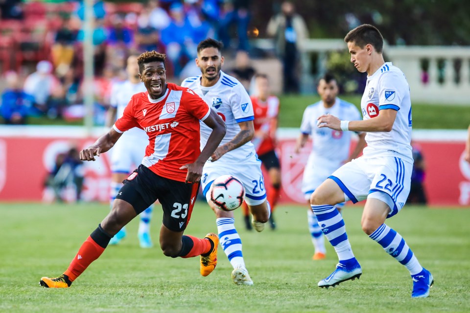 Cavalry FC attacker Dominique Malonga battles against Montreal Impact defender Jukka Raitala in the second leg of the Canadian Championship at Spruce Meadows on Aug. 14. (BRENT CALVER/Western Wheel)