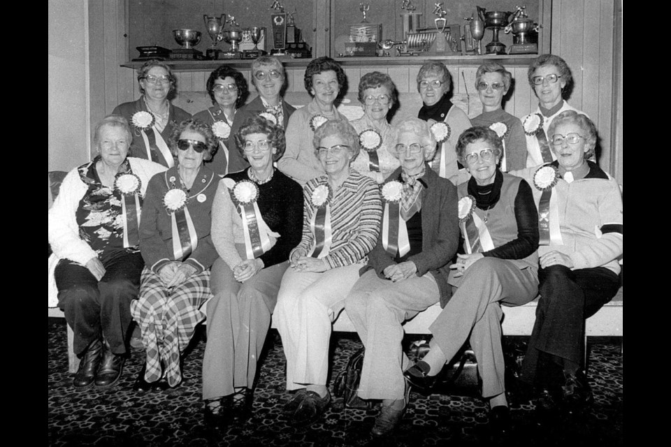 Founding members of the Okotoks Ladies' Curling Club celebrating the 25th anniversary of the club in 1982. Back row: Louise Holmes, Hazel Snodgrass, Evelyn Johnson, Jean Milligan, Chris Poffenroth, Chris Aikens, Lucille Cole and Dot Jesperson. Front row: Mary Wild, Winnie Carr, Audrey Hoiland, Jean Packenham, Myrtle MacDonald, Margaret Aggett and Kay Christensen. (Photo courtest of the Okotoks Museum & Archives)