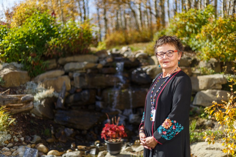 Executive Director, Dawn Elliot, poses on the Foothills Country Hospice Society property on Oct. 5. (Photo by Devon Langille Photography)