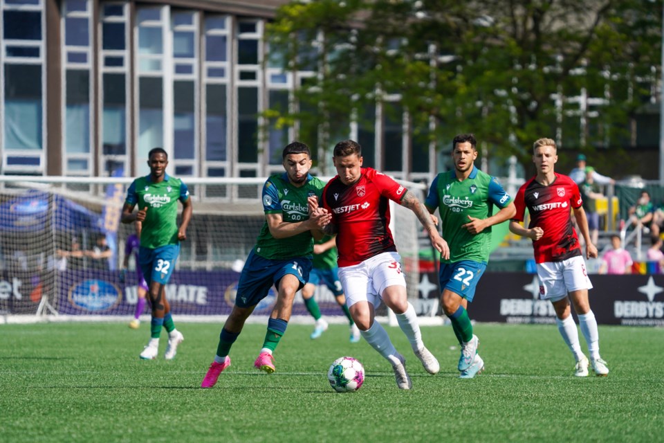 Cavalry FC's Fraser Aird, right battles with York United's Oussama Alou during York's 1-0 win in CPL action on May 28 at York Lions stadium in North York, ONT.