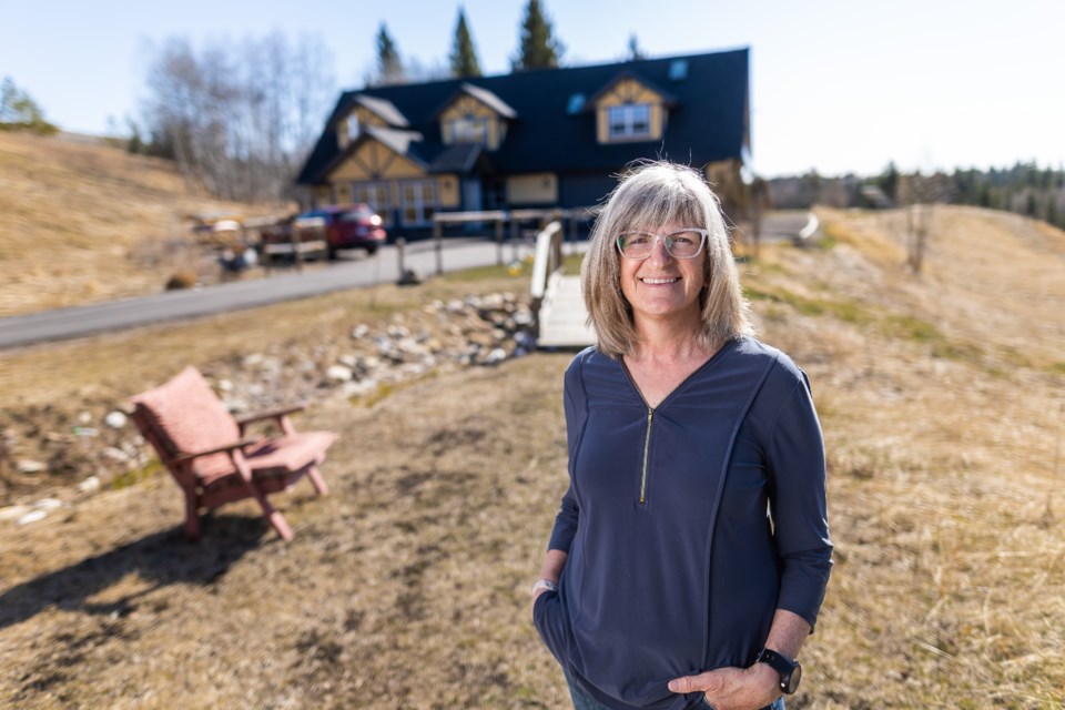Sarah Kilby, proprietor of Windflower Bed and Breakfast, in front of her B&B on April 21. Windflower is located 4 kilometres west of Turner Valley on Highway 546. (Brent Calver Photo)