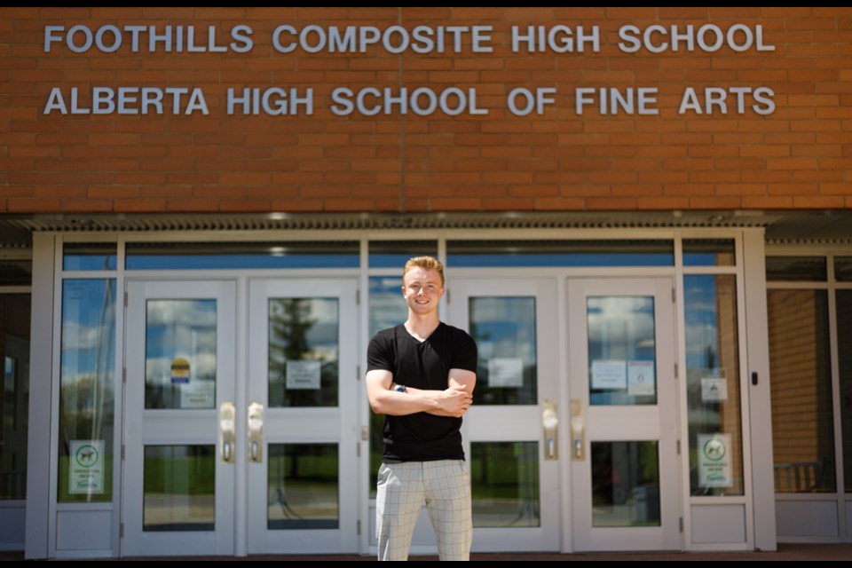 Foothills Composite class
of 2020 graduate Nathan
Fox poses just outside the
Okotoks school on June 8.
(Photo by Devon Langille)