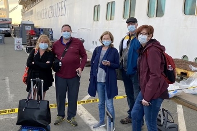 A group of passengers stands outside the Grand Princess cruise ship after it docked in Oakland due to the COVID-19 pandemic. (photo submitted)