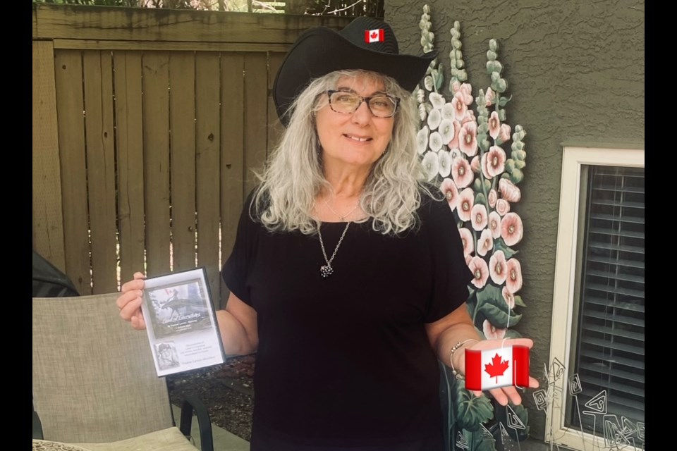Yvonne Martinez with the CD for her song 'Land of Everything.'