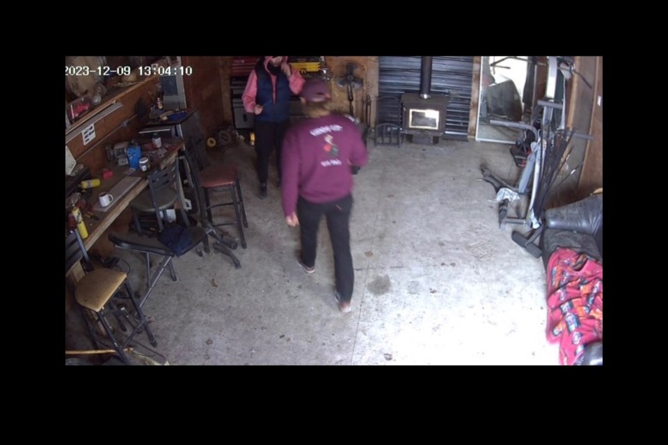 The robbery suspect, back left, is confronted at the Saskatoon Farm on Dec. 9.