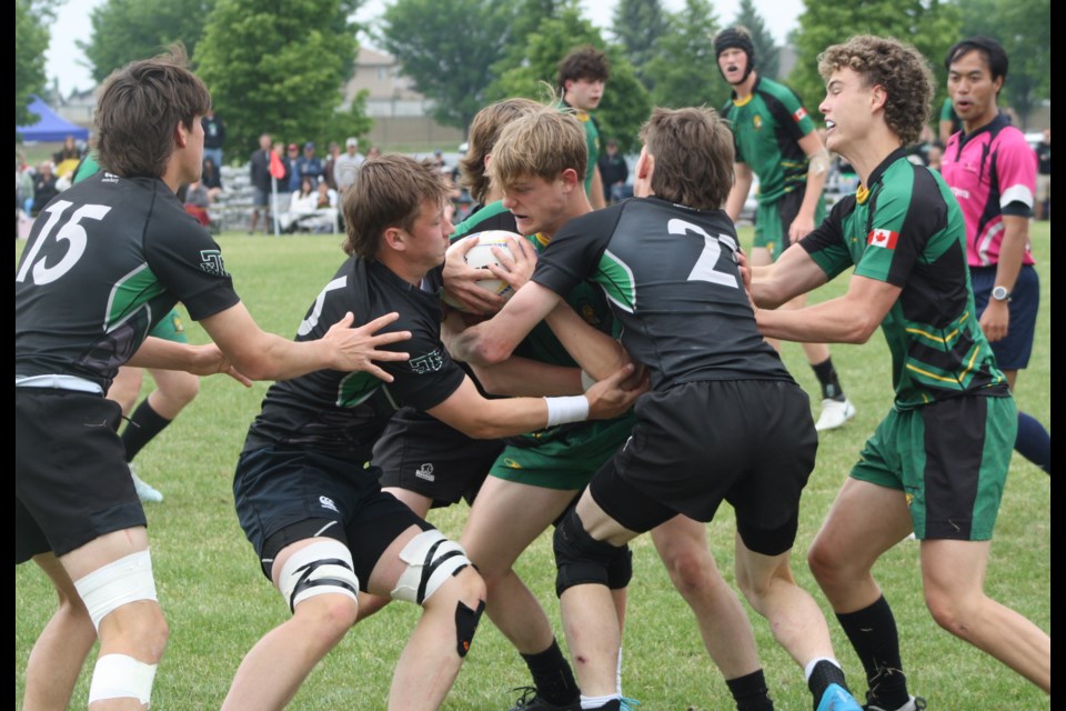 The Holy Trinity Academy Knights defence stuffs an offensive attack from the Bowness Trojans during the ASAA Tier 1 Rugby final on June 7 in Lethbridge. HTA won by a 29-0 score to repeat as provincial champions. 
