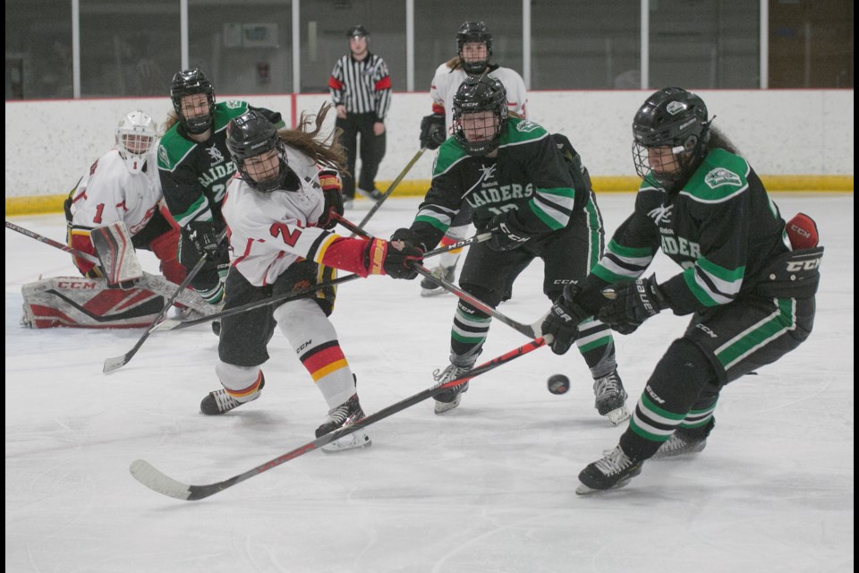 Rocky Mountain Raiders forwards Raquel Ingram and Asha Kailey converge on Calgary Fire Bailey Fiala during the Raiders' 4-3 win on Feb. 23 at Scott Seaman Sports Rink.
(Remy Greer/Western Wheel)