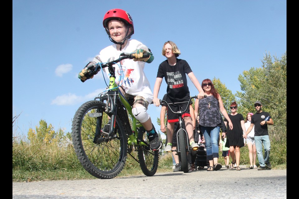From left, Raymond MacNeil, five, brother Daniel MacNeil, 10, and mother Ellen MacNeil participate in a family-wide Terry Fox Run at Air Ranch Wildlife Preserve on Sept. 20, with Raymond being the inspiration behind making it a fundraising event for the Terry Fox Foundation. (Tammy Rollie/Western Wheel)