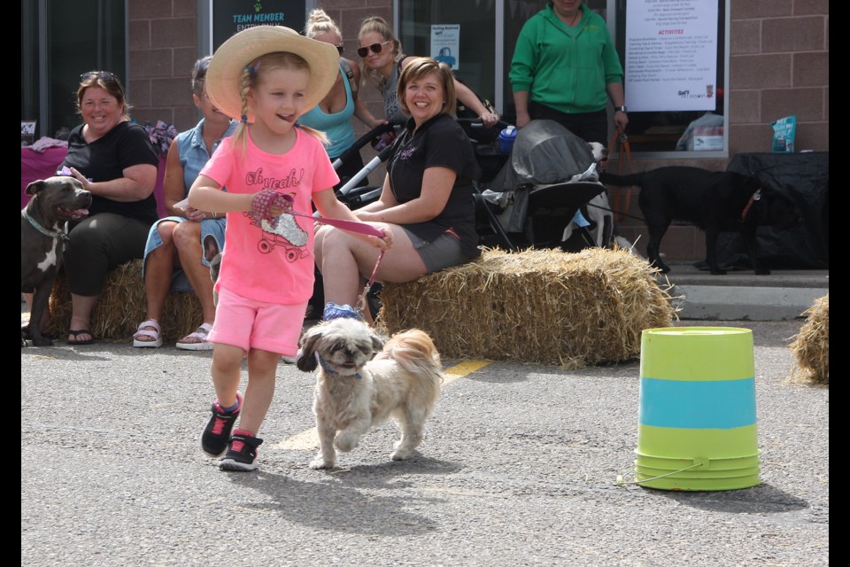 Five-year-old Delilah Maurice and Kahlúa get around a barrel during a race at Gus's Pet Resort's Stampede Pupcake Breakfast on July 13. (Bruce Campbell, Western Wheel)