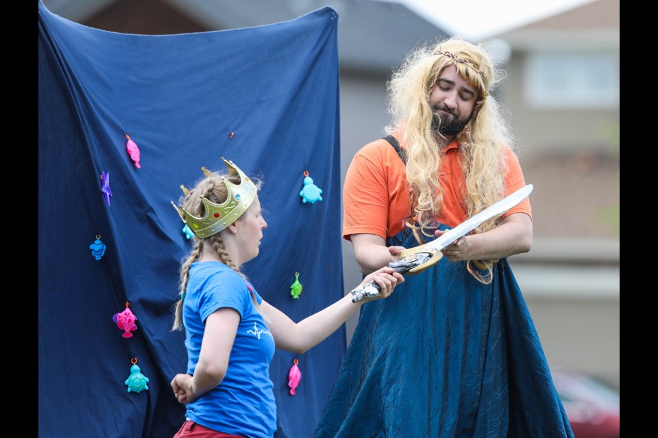 The Lady of the Lake (played by Alan Johnson) bestows a magical sword unto King Arthur (Kelly Malcolm) in Win the Warrior: A King Arthur Tale by Goodger Pink Family Theatre on July 6. (BRENT CALVER/Western Wheel)
