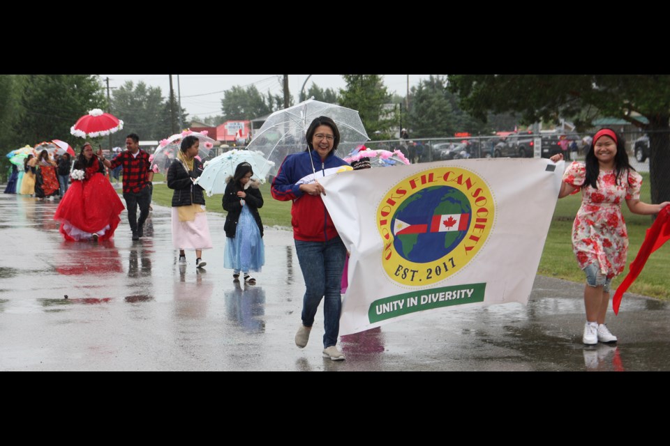 Okotoks Fil-Can Society members make their way through Longview in the Little New York Daze parade Saturday morning.