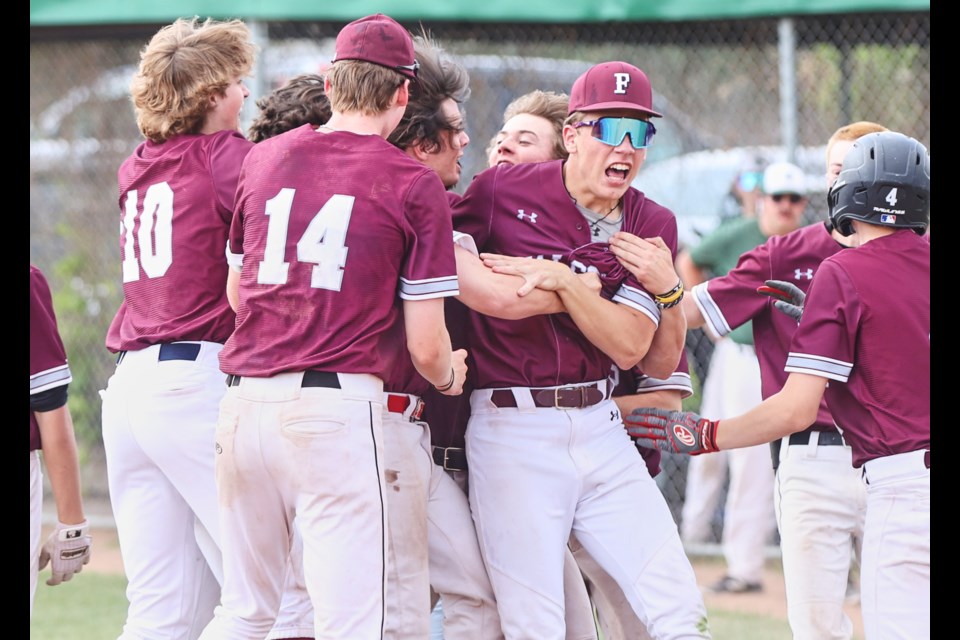 The Foothills Falcons celebrate at home plate after scoring the winning run to earn a walk-off 5-4 victory over the Holy Trinity Academy Knights to win the Southern Alberta High School Baseball League Tier I provincial championship on May 27 at Littler Field in Okotoks. 