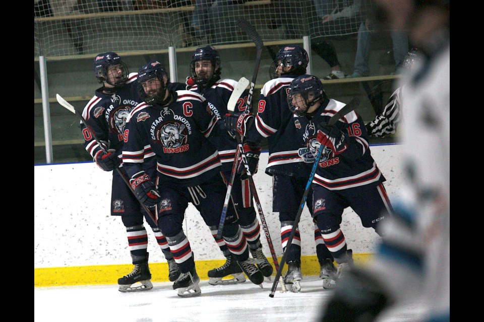 Carstar Okotoks Bisons captain Lucas Watkins celebrates his third period goal with teammates during the 6-1 win over the Sylvan Lake Wranglers on Feb. 10 at Murray Arena.