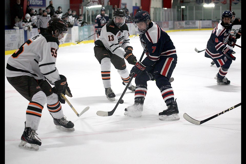 Carstar Okotoks Bisons forward Nolan Smith battles for the puck against the Medicine Hat Cubs during Heritage Junior Hockey League action on Jan. 26 at the Murray Arena. Smith scored his first goal with the team in the 4-1 victory.