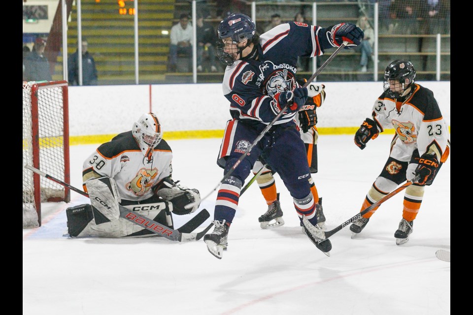 Carstar Okotoks Bisons forward Jady Shigehiro gets airborn for a deflection in front of goal versus the Coadale Copperheads on Feb. 2 at the Murray Arena. Okotoks clinched first place in the South Division with the 4-1 victory. 