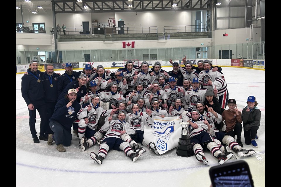 The Carstar Okotoks Bisons pose with the banner after winning the 2024 Hockey Alberta Junior B Provincial Championship with a 6-3 win over La Crete on April 7 in Peace River.
