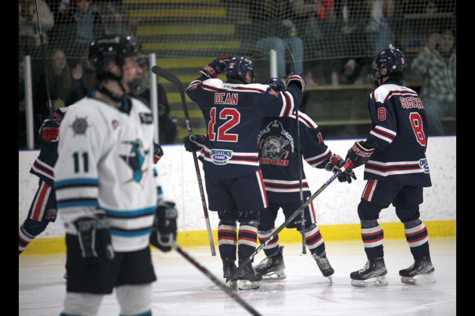 Owen McFarlane celebrates his second period goal with Carstar Okotoks Bisons teammates Easton Dean and Jady Shigehiro during Game 3 of the HJHL Final on March 22 at the Murray Arena. Okotoks won 5-3 to take a 2-1 series lead. 