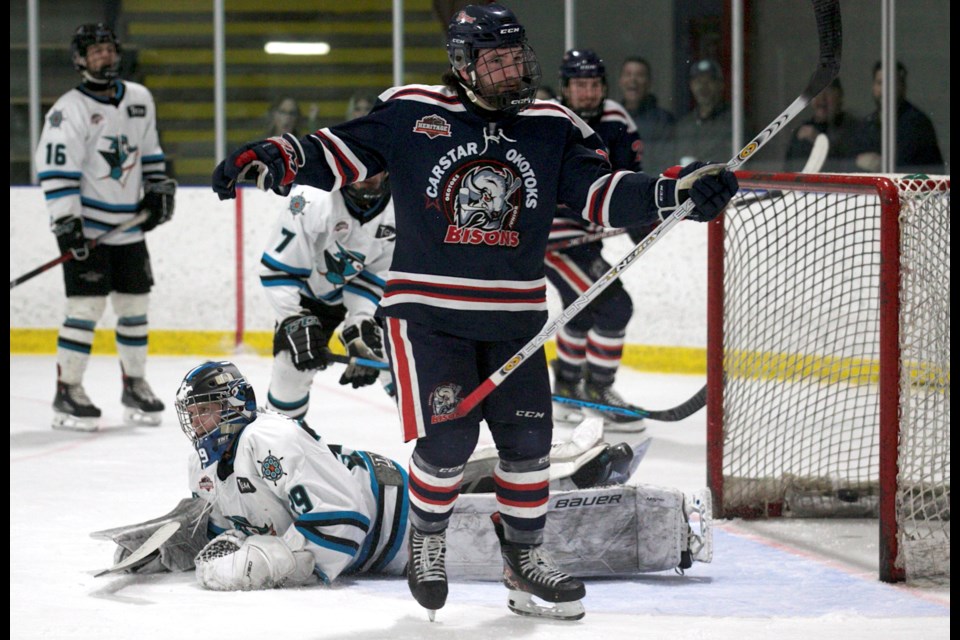 Carstar Okotoks Bisons forward Scott Brown celebrates a first period goal on Sylvan Lake Wranglers netminder Kaden Toussaint during Game 1 of the HJHL final on March 16 at Okotoks’ Murray Arena.