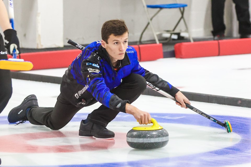 Foothills County curler Ben Kiist throws during a past provincial qualifying event in Okotoks. Kiist and Okotokian Logan Thomas are headed to the Canadian U18 Championships in Timmins, Ont. as members of Team Davies, one of two Alberta boys teams at the event. (Brent Calver/OkotoksTODAY File Photo)