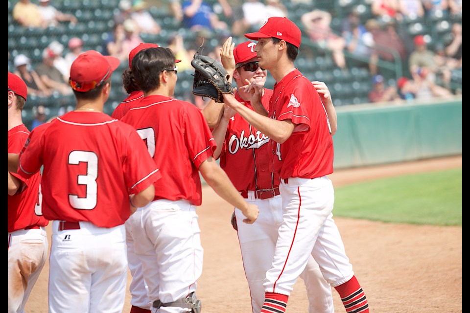 Brody Forno is congratulated by teammates after tossing a scoreless eighth inning out of the bullpen in Dawgs Red's 5-2 victory over Sylvan Lake on July 3 at Seaman Stadium. (Remy Greer/Western Wheel)