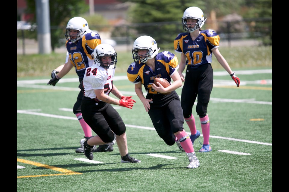 Foothills Eagles running back Alyssa Monaghan runs in a successful convert during the June 4 game versus the Airdrie Raiders at Shouldice Park. Airdrie won 34-31.