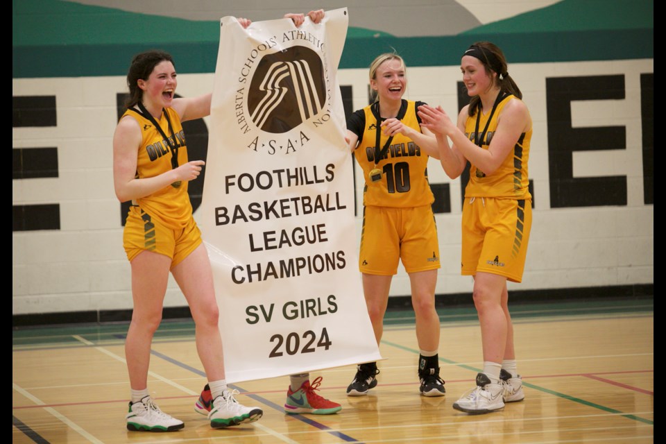 The Oilfields Drillers captains are presented the Foothills Athletic Council senior girls basketball banner after defeating the Highwood Mustangs 71-32 on Feb. 28 at the Diamond Valley school.