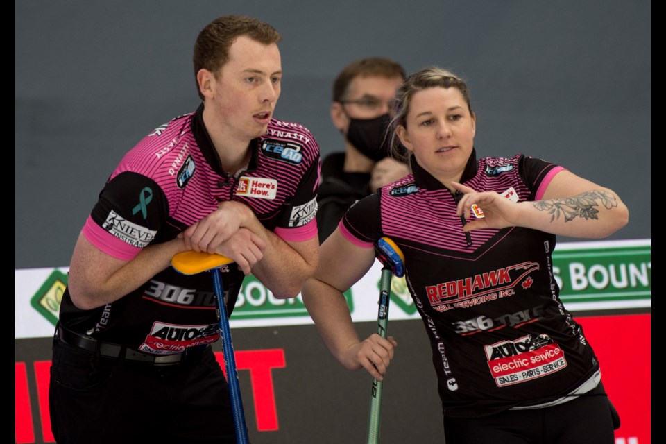 Okotoks’ Kyler Kleibrink, left, and Chaelynn Kitz survey the scene during their victory over Lauren and Alex MacFadyen at the 2021 Canadian Mixed Doubles Curling Championship at Calgary’s WinSport. (Curling Canada/ Michael Burns Photo)