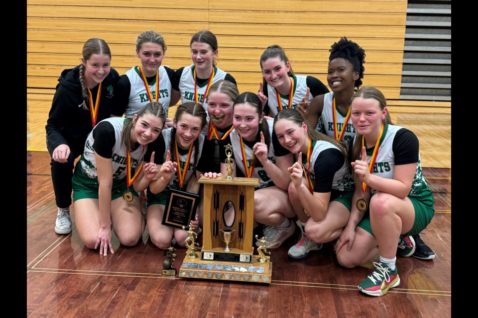 The Holy Trinity Academy Knights senior girls basketball squad poses after winning the Cardinal Classic tournament on Feb. 3 at Bishop Carroll High School in Calgary.