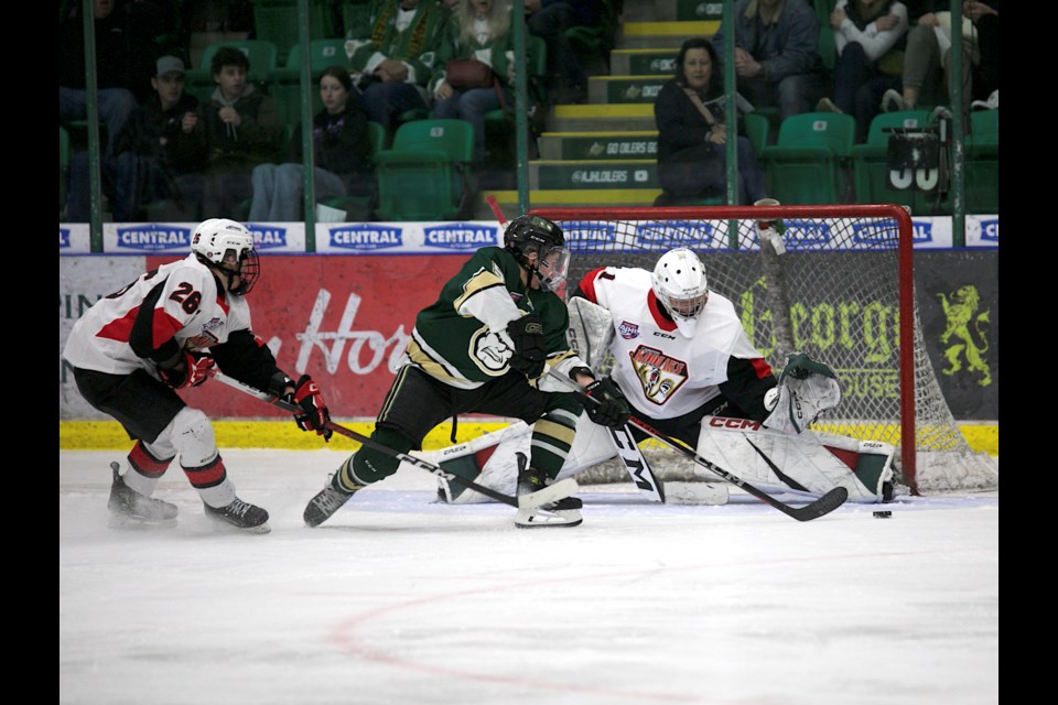 Okotoks Oilers forward Brett Wilson reaches for the puck on a partial breakaway during the 2-1 win over the Camrose Kodiaks on Jan. 1 at the Centennial Arenas.