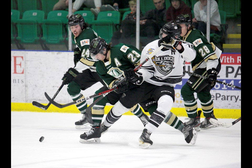 Okotoks Oilers defenceman Logan Magowan gets tied up with Blackfalds Bulldog Brendan Ross during the regular season home finale for Okotoks on April 5 at the Centennial Arenas. Blackfalds won 6-5 to clinch third in the BCHL Alberta Division, with Okotoks locked into fourth spot. 