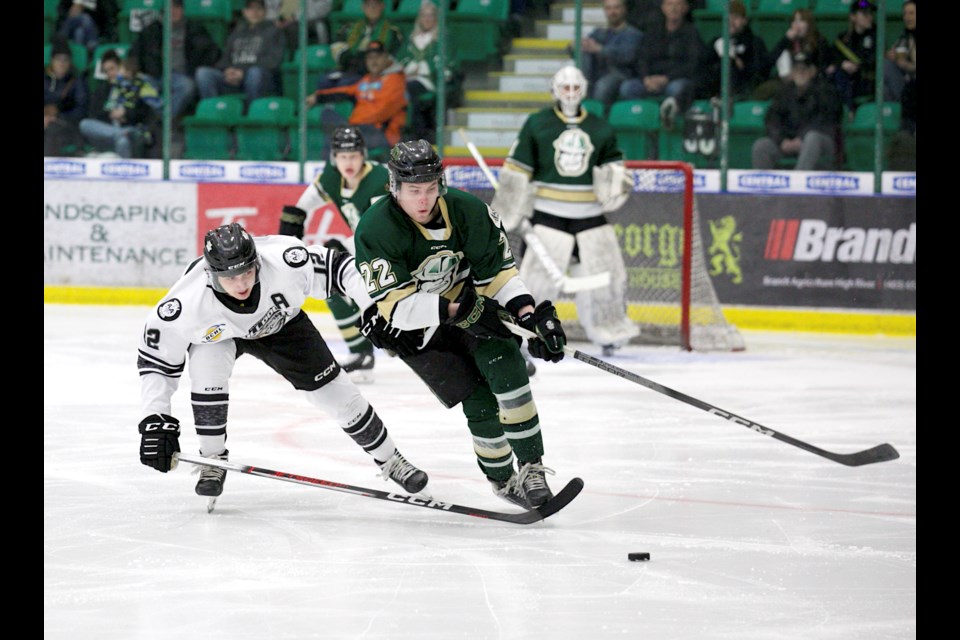 Okotoks Oilers defenceman Brody Maguire protects the puck from Blackfalds Bulldog Jayden Joly during the BCHL match on March 24 at the Centennial Arenas. Blackfalds won 2-1. 