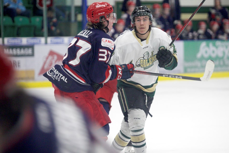 Okotoks Oilers forward Jack Silverberg clashes with Brooks Bandits blueliner Quinn McCall during Game 3 of the BCHL Alberta Division semifinal on April 23 at Okotoks Centennial Arenas.