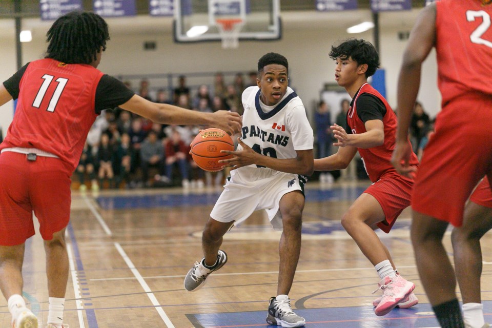 STS Spartan Uzonna Nwachukwu cuts to the basket during the team’s 71-62 defeat versus the Heritage Christian Hawks at the Spartans Invitational senior boys and girls basketball tournament on Feb. 23. STS finished with a 2-1 record at the event.