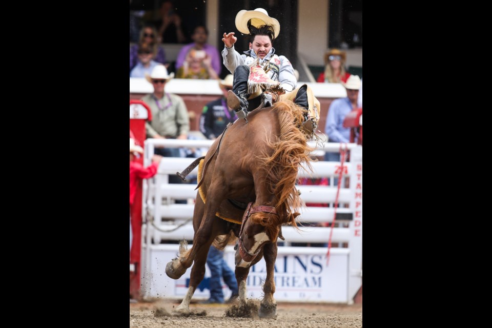 Ty Taypotat rides Zig Zag Cherry on day four of the Calgary Stampede Rodeo on July 8. (BRENT CALVER/Western Wheel)